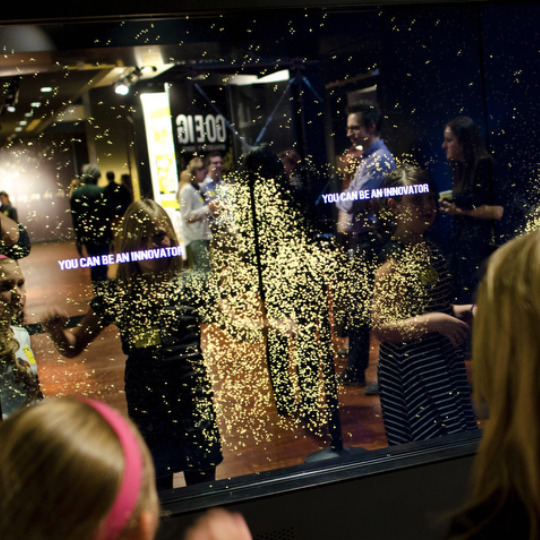 Visitors interacting with a touch-screen exhibit at the Bezos Center for Innovation at the Museum of History and Innovation