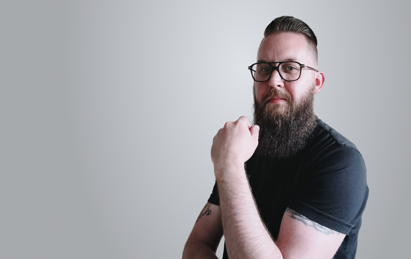 portrait of John Wayne Hill reading a book in a San Francisco park