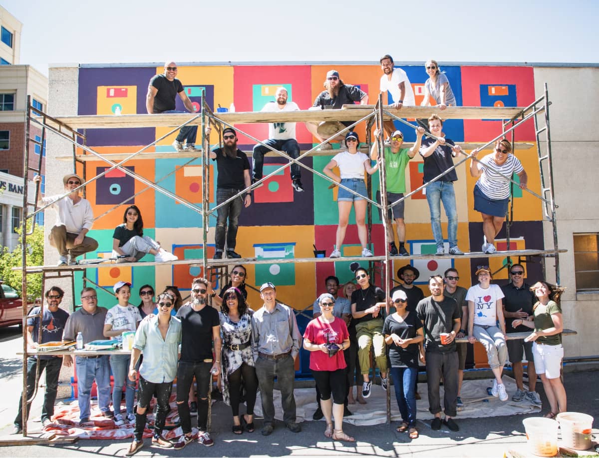 John Wayne Hill with Ancestry UX team designing and painting a mural in Lehi, Utah.